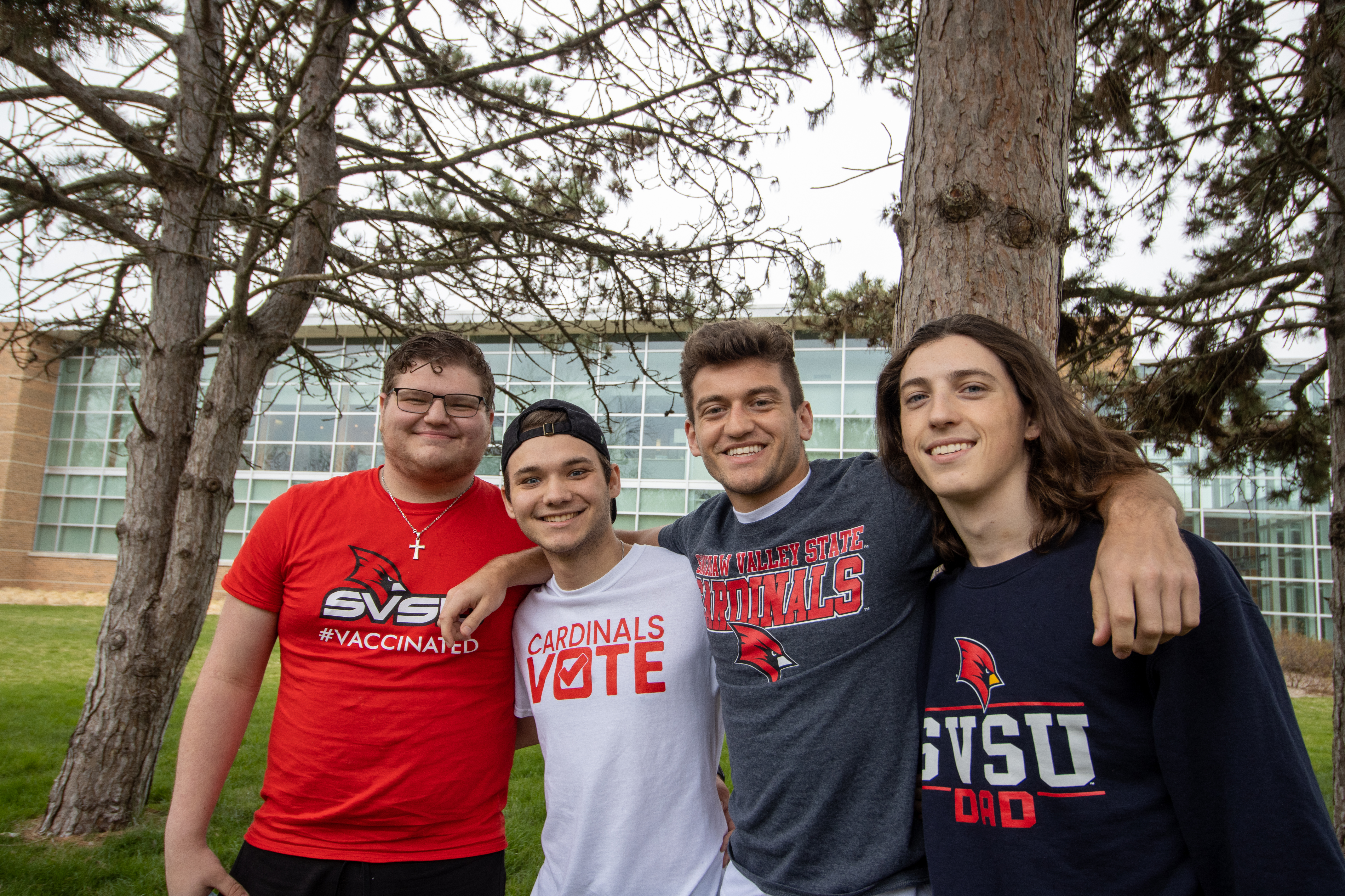 Students looking happy near Pioneer Hall